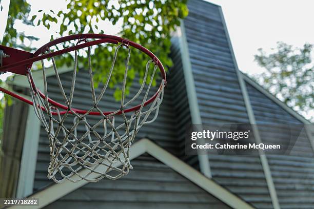 basketball hoop beside residential home - basketball hoop pole stock pictures, royalty-free photos & images