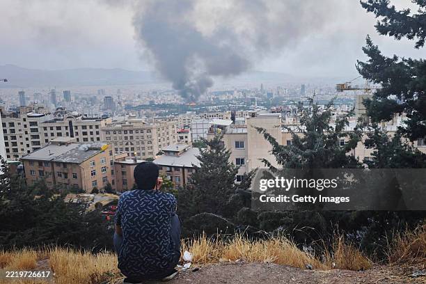 Smoke rises after a reported Israeli strike on a building used by Islamic Republic of Iran News Network, part of Iran's state TV broadcaster, on June...