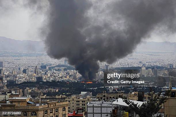 Smoke rises after a reported Israeli strike on a building used by Islamic Republic of Iran News Network, part of Iran's state TV broadcaster, on June...