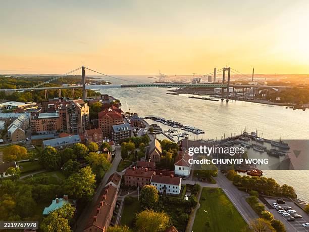gothenburg skyline at sunset with älvsborg bridge and göta älv river - gothenburg stock pictures, royalty-free photos & images