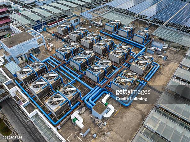 central air conditioning on factory roof - kondensator stock-fotos und bilder