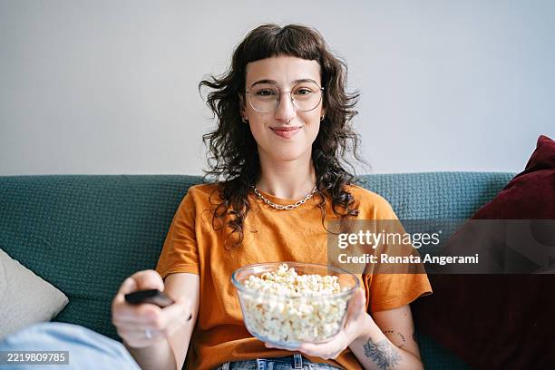 young woman in personal perspective watching tv - spectator stock pictures, royalty-free photos & images