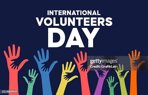 international volunteers day celebration with raised hands in various colors - volunteer stock illustrations