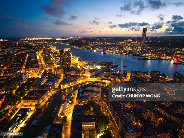 gothenburg skyline illuminating at dusk, captured by drone - göteborg stad bildbanksfoton och bilder