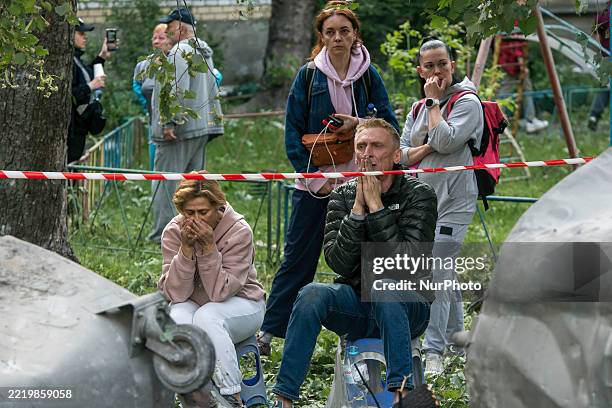 Family members of those still missing under the debris are at the site of a residential building hit by a Russian ballistic missile during a massive...
