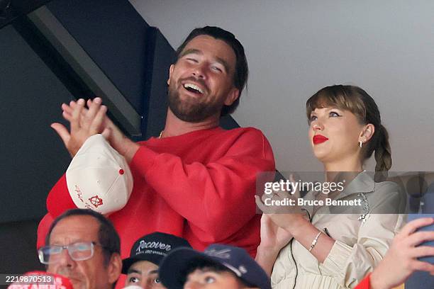 Travis Kelce, left, and Taylor Swift react as the Edmonton Oilers and the Florida Panthers play during the first period in Game Four of the 2025...