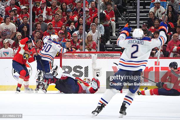 Corey Perry of the Edmonton Oilers celebrates the overtime goal by teammate Leon Draisaitl during the third period of Game Four of the 2025 Stanley...