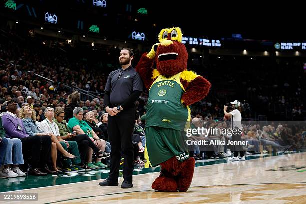 Doppler, the Seattle Storm mascot, leans on a security guard during the game against the Minnesota Lynx at Climate Pledge Arena on June 11, 2025 in...