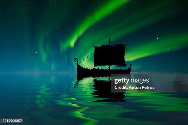 viking ship at sea under the northern lights - viking ship stock pictures, royalty-free photos & images