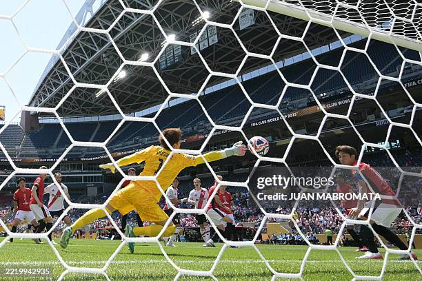 River Plate's Argentine midfielder Maximiliano Meza heads the ball against Urawa Red Diamonds' Japanese goalkeeper Shusaku Nishikawa and scores his...