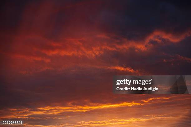 vibrant sunset clouds orange and purple - alsace nature stock pictures, royalty-free photos & images
