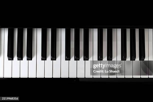 piano and piano keyboard with black backgrounds. - tasto di pianoforte foto e immagini stock