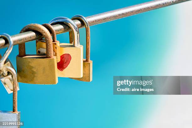 love locks hanging on a bridge railing representing eternal love - endless bridge stock pictures, royalty-free photos & images
