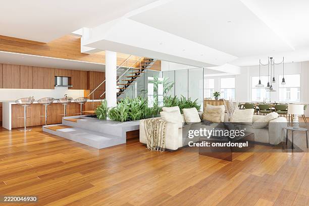 modern living room with corner sofa, dining table and chairs, open plan kitchen and staircase - parket stockfoto's en -beelden