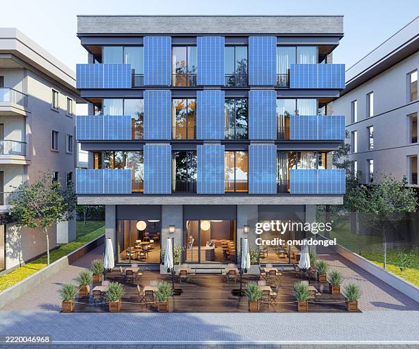 modern building with solar panels on the facade. green technology, environmental conservation and sustainable resources concept - solar panel array front view stock pictures, royalty-free photos & images