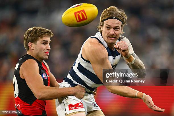 Matt Guelfi of the Bombers tackles Tom Stewart of the Cats during the round 14 AFL match between Essendon Bombers and Geelong Cats at Melbourne...