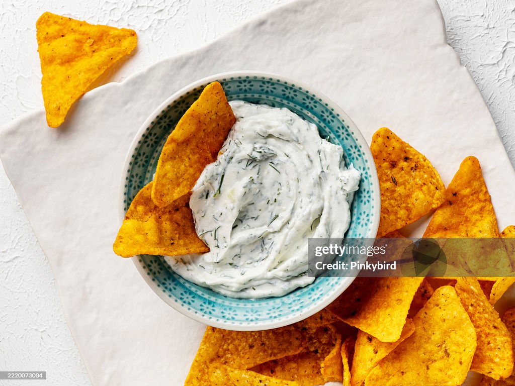 Ranch dipping Sauce. Dipping Sauce with potato chips. Homemade Organic Ranch Sauce. Ranch dipping sauce and Chip.