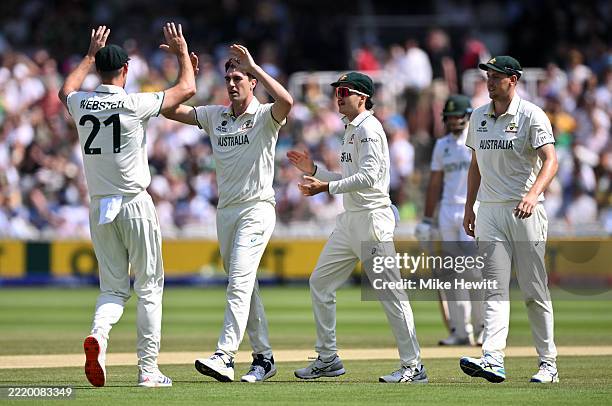 Pat Cummins of Australia celebrates with team mates Beau Webster, Sam Konstas and Cameron Green after taking the wicket of Temba Bavuma of South...