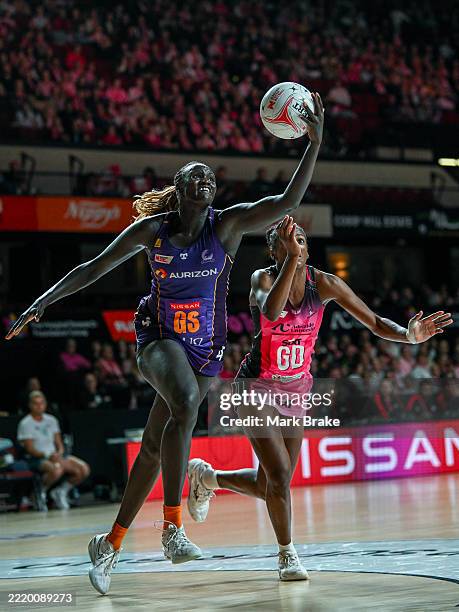 Mary Cholhok of the Firebirds catches the ball in front of Latanya Wilson of the Thunderbirds during the round 10 Super Netball match between...
