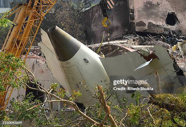 Crane retrieves part of the fuselage of the Air India Boeing 787 on June 14, 2025 in Ahmedabad, India. An Air India Boeing 787 Dreamliner, flight...