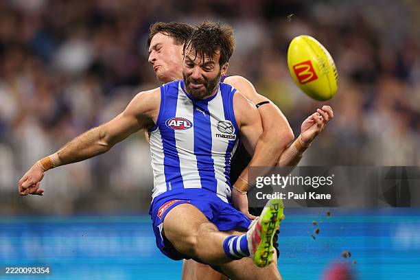 Luke McDonald of the Kangaroos clears the ball during the round 14 AFL match between North Melbourne Kangaroos and Fremantle Dockers at Optus...