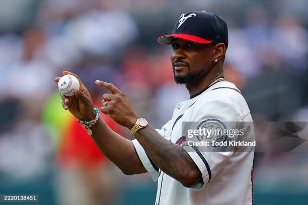 Entertainer Usher throws out the ceremonial first pitch prior to the game between the New York Mets and Atlanta Braves at Truist Park on June 18,...