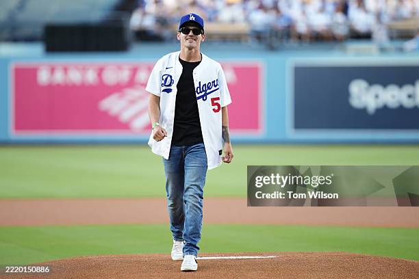 Musician and songwriter Mikey Way smiles after throwing a ceremonial first pitch prior to the game between the San Diego Padres and the Los Angeles...