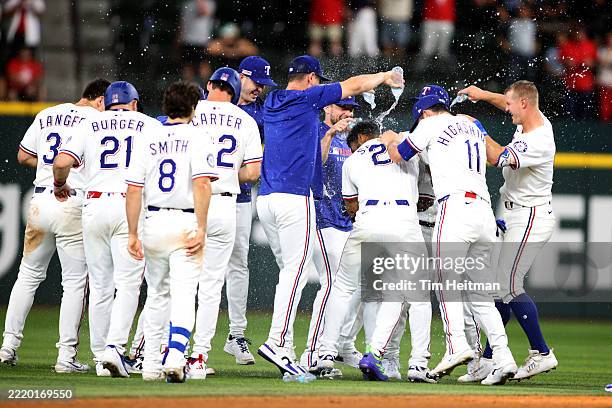 Texas Rangers players celebrate a walk-off single by teammate Adolis Garcia during the eleventh inning against the Chicago White Sox at Globe Life...