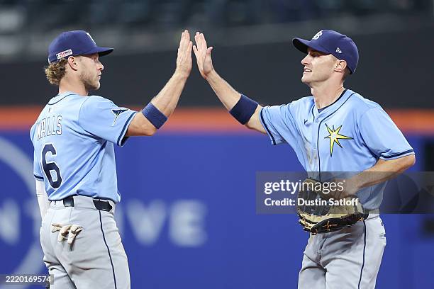 Jake Mangum of the Tampa Bay Rays and Taylor Walls of the Tampa Bay Rays celebrate after defeating the New York Mets 8-4 in the game at Citi Field on...