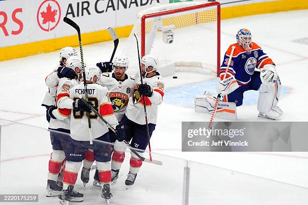 Sam Bennett of the Florida Panthers is congratulated by teammates after scoring a goal against Calvin Pickard of the Edmonton Oilers during the first...