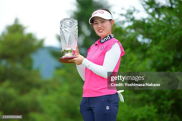 Asuka Minayoshi of Japan poses with the trophy following the final round of ROUTE INN CUP at Ueda Maruko Grandvrio Golf Club on June 15, 2025 in...