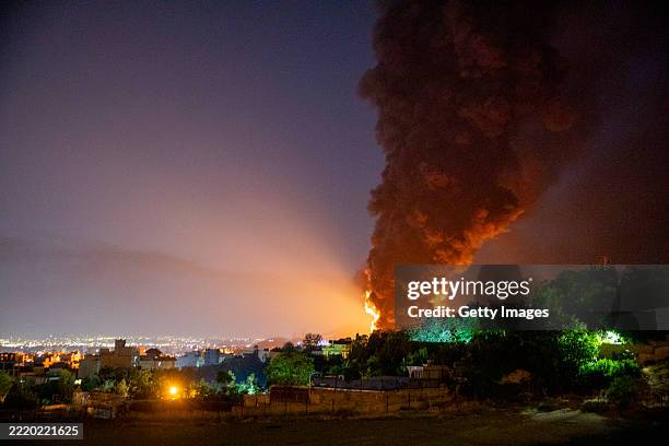 Fire and smoke rise into the sky after an Israeli attack on the Shahran oil depot on June 15, 2025 in Tehran, Iran. Iran's foreign minister said the...