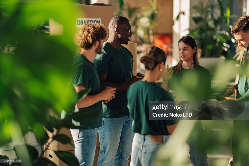 Volunteers discussing during donation drive in office