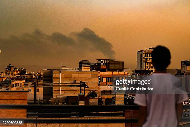 General view of Tehran covered in smoke and dust following explosions after an Israeli airstrike, on June 15, 2025 in Tehran, Iran. Iran's foreign...
