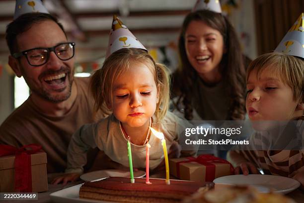 blowing birthday candles on a cake! - verjaardagskaars stockfoto's en -beelden