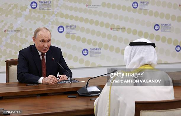 Russia's President Vladimir Putin meets OPEC Secretary General Haitham Al Ghais during the Saint Petersburg International Economic Forum in Saint...