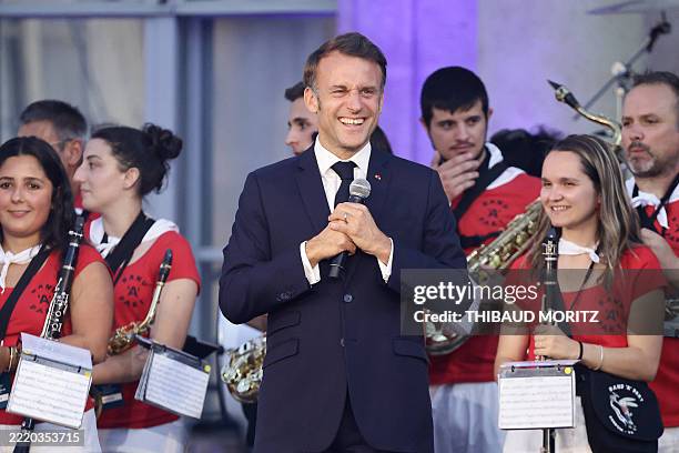 French President Emmanuel Macron reacts as he delivers a speech on stage during an event for the "France Music Week", a day before the "Fete de la...