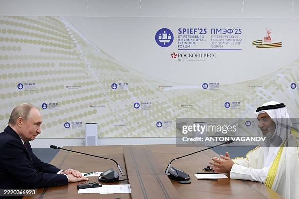 Russia's President Vladimir Putin meets OPEC Secretary General Haitham Al Ghais during the Saint Petersburg International Economic Forum in Saint...