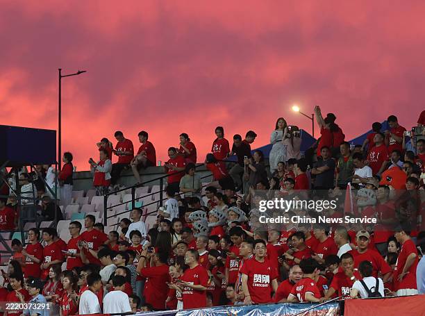Football fans cheer for players in a match between Team Wuxi and Team Changzhou during fourth-round of the Jiangsu Football City League,...