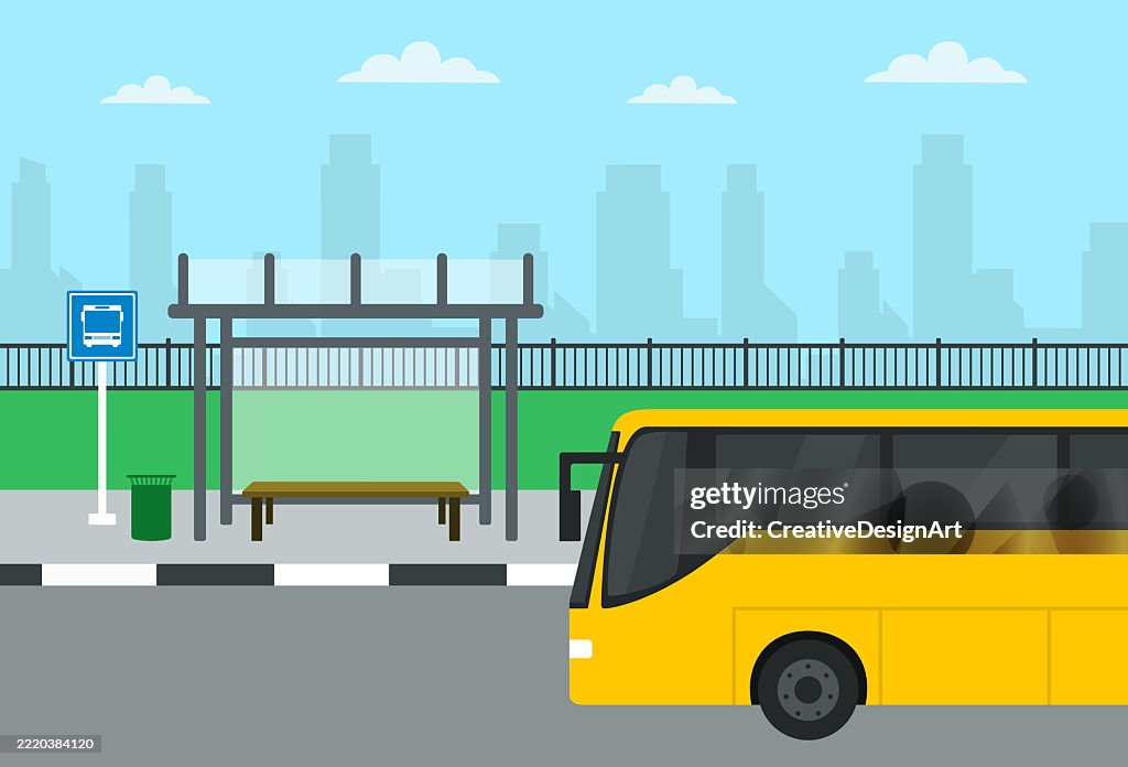Bus Stop With Yellow City Bus In Front Of City Skyline