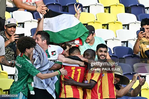 Esperance's Algerian midfielder Youcef Belaili celebrates with teammates after scoring his team's first goal during the FIFA Club World Cup 2025...