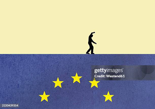 silhouette of a person walking on a european union flag symbolizing political and economic uncertainty - europaflagge stock-grafiken, -clipart, -cartoons und -symbole
