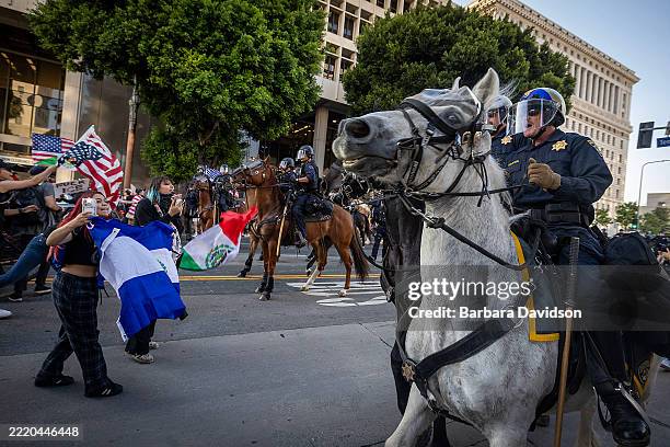 Los Angeles Metropolitan Police, on horseback, clear protesters from demonstrating in front of the City Hall building in downtown, Los Angeles, June...