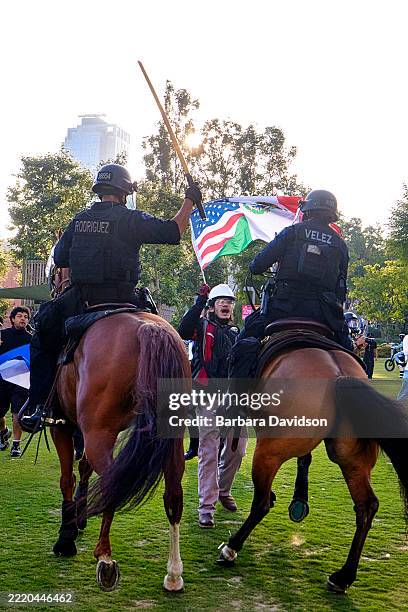 Los Angeles Metropolitan Police, on horseback, clear protesters from demonstrating in front of the City Hall building in downtown, Los Angeles, June...
