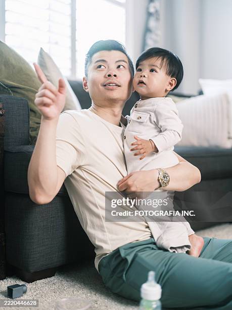 young korean father at home playing with toddler son - korean people stock pictures, royalty-free photos & images