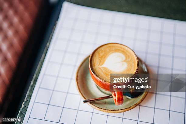 feshly brewed latte coffee on a table. - cafe latte art stock pictures, royalty-free photos & images