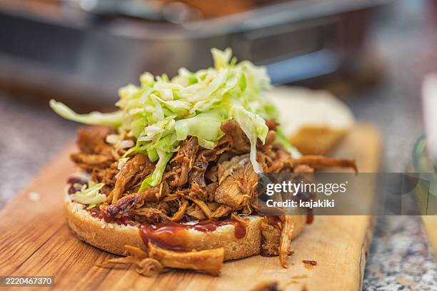 homemade pulled pork sandwich with coleslaw and barbecue sauce - shredded cabbage stock pictures, royalty-free photos & images