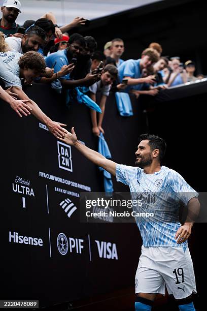 Ilkay Gundogan of Manchester City FC greets the fans as he enters the field of play for warm up prior to the FIFA Club World Cup football match...