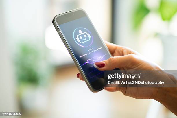 woman using her smartphone to ask ai chatbot questions. - virtual assistant stock pictures, royalty-free photos & images