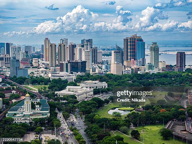 aerial view of manila's skyline with green parks and modern architecture - metro manila stock pictures, royalty-free photos & images